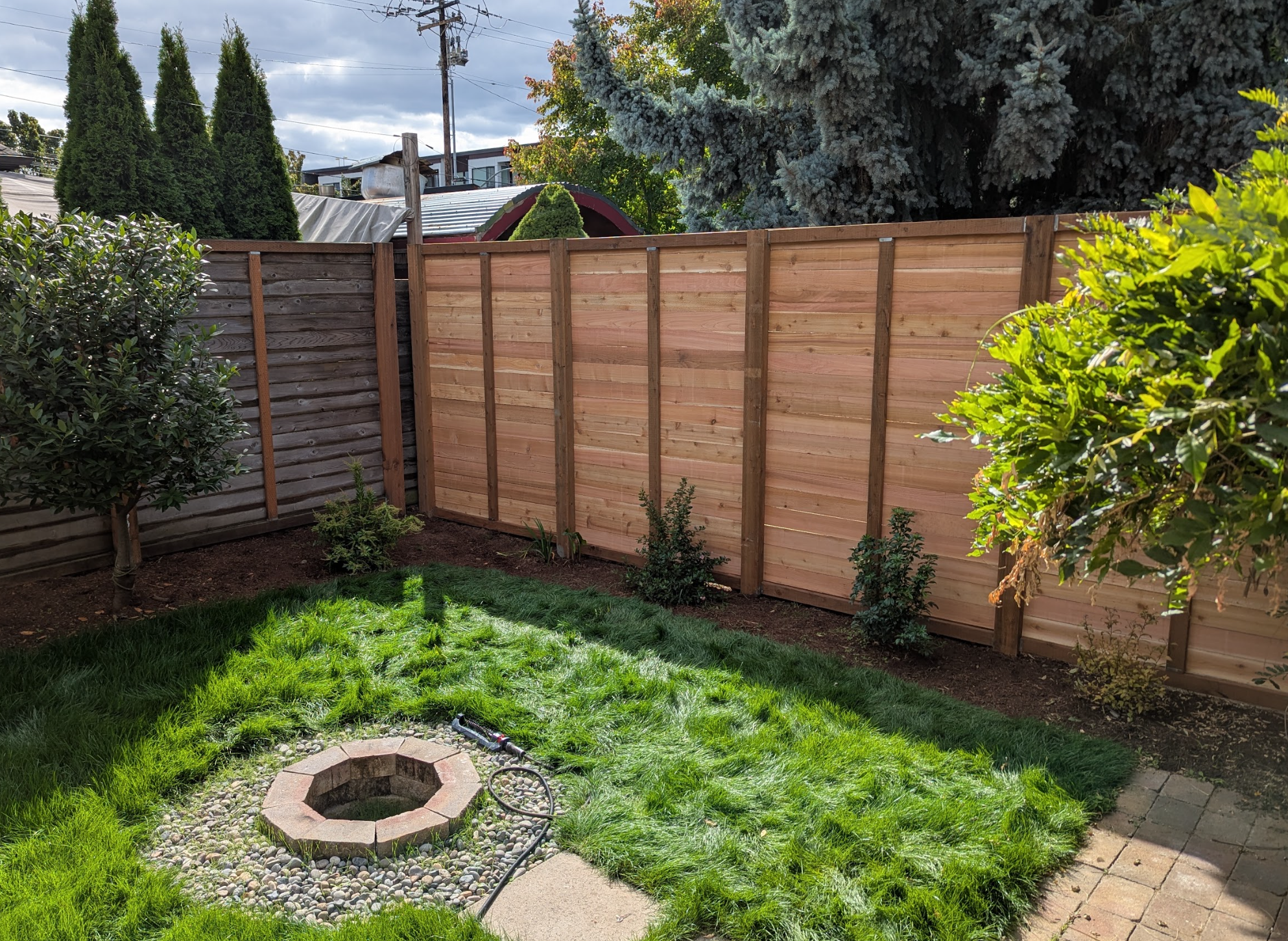 Nearly nine-foot-high wooden fence added to match an existing side fence at a Portland home